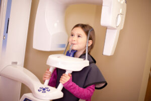 Young Girl at Dentist Getting X-Rays of Teeth