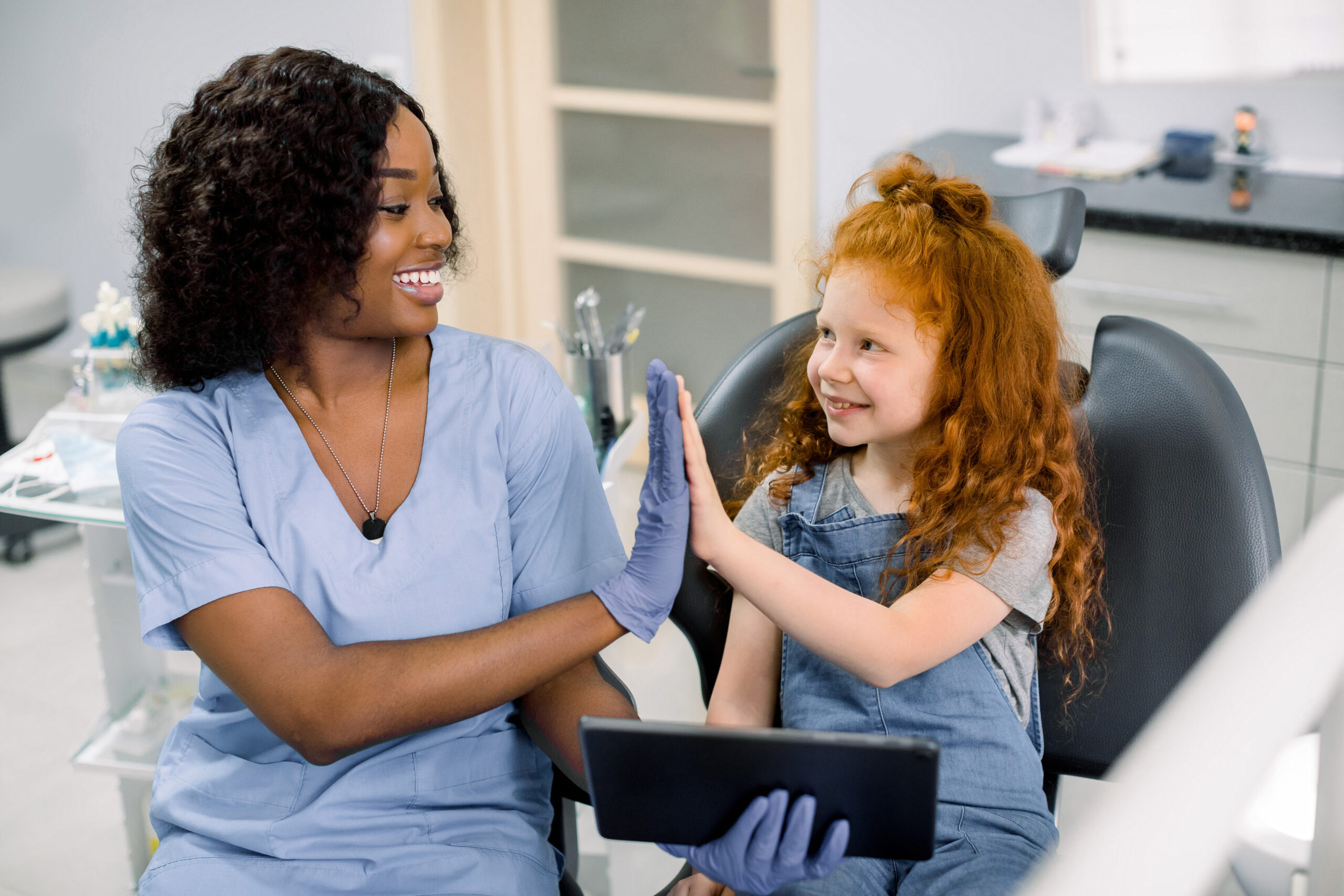 Pediatric dentist providing gentle dental care to a young child